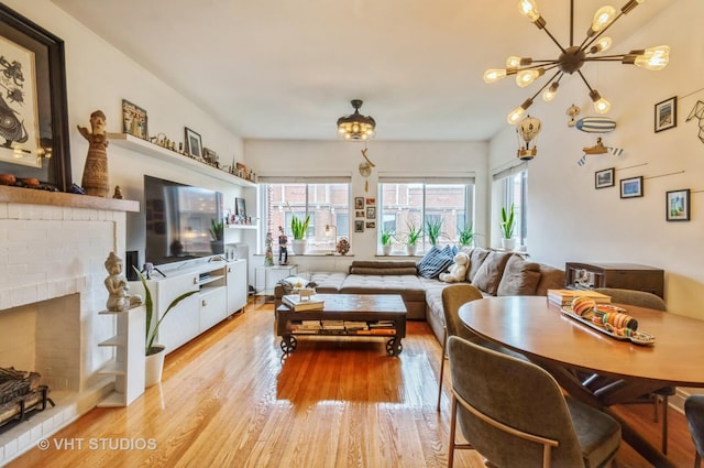 932 W Sunnyside Ave Unit 3C, Chicago, IL 60640 - living area with plenty of natural light, wood finished floors, a chandelier, and a fireplace