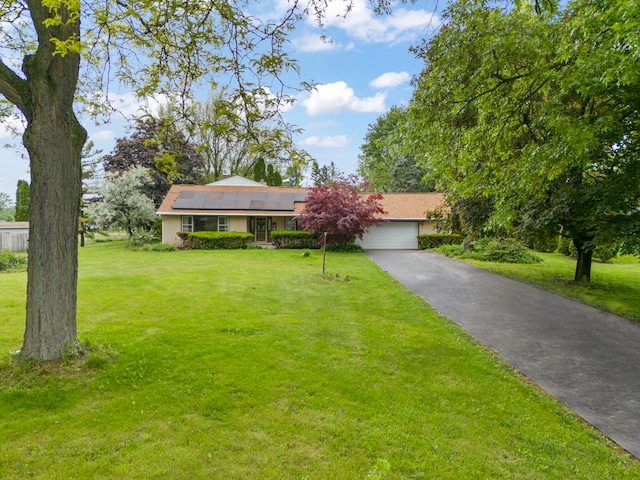 742 Crest Ave, Schaumburg, IL 60193 - view of front of house with driveway, roof mounted solar panels, a front lawn, and an attached garage