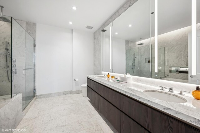 363 E Wacker Dr Unit 3703, Chicago, IL 60601 - bathroom featuring a marble finish shower, double vanity, marble finish floors, recessed lighting, and toilet