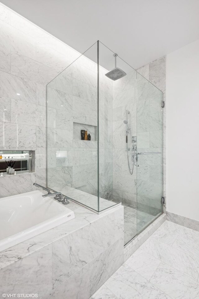 363 E Wacker Dr Unit 3703, Chicago, IL 60601 - bathroom featuring a marble finish shower, a bath, and baseboards