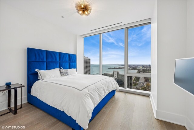 363 E Wacker Dr Unit 3703, Chicago, IL 60601 - bedroom with a water view, floor to ceiling windows, wood finished floors, and baseboards