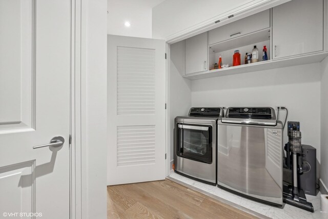 363 E Wacker Dr Unit 3703, Chicago, IL 60601 - laundry room featuring washer and dryer, cabinet space, and light wood-type flooring