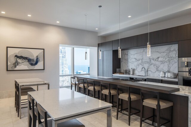 363 E Wacker Dr Unit 3703, Chicago, IL 60601 - kitchen with a kitchen island, decorative backsplash, recessed lighting, modern cabinets, and a sink