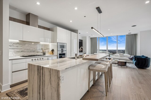 363 E Wacker Dr Unit 3703, Chicago, IL 60601 - kitchen with modern cabinets, white gas cooktop, decorative backsplash, light wood-type flooring, and a wall of windows
