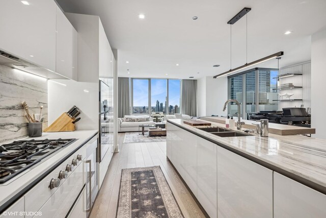 363 E Wacker Dr Unit 3703, Chicago, IL 60601 - kitchen featuring a sink, modern cabinets, white cabinetry, expansive windows, and light wood-type flooring