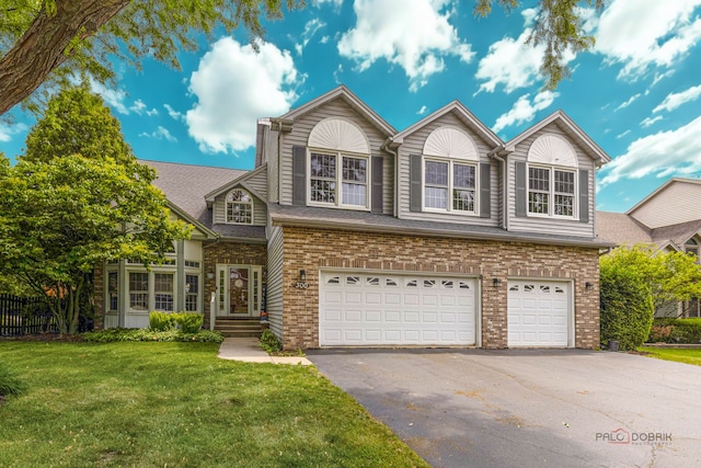 300 Knox Park Rd, Lake Zurich, IL 60047 - traditional-style house with a garage, asphalt driveway, a front lawn, and brick siding