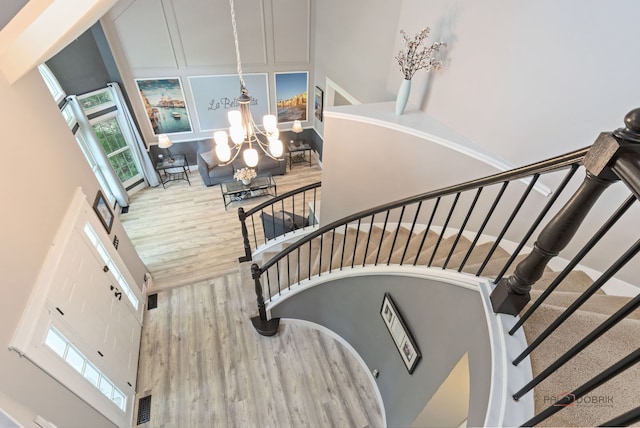 300 Knox Park Rd, Lake Zurich, IL 60047 - staircase featuring a towering ceiling, a chandelier, healthy amount of natural light, and wood finished floors
