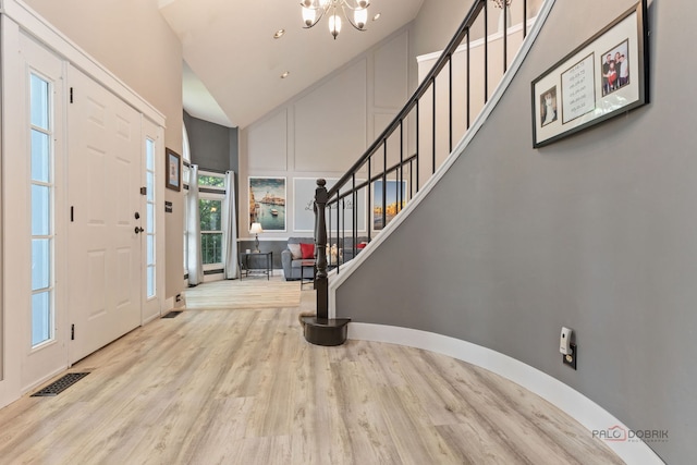 300 Knox Park Rd, Lake Zurich, IL 60047 - entrance foyer featuring high vaulted ceiling, a chandelier, wood finished floors, and stairway