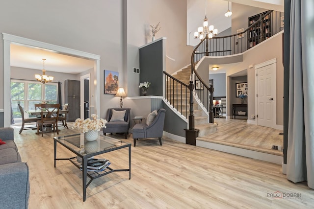 300 Knox Park Rd, Lake Zurich, IL 60047 - living room featuring a chandelier, stairway, a towering ceiling, and wood finished floors