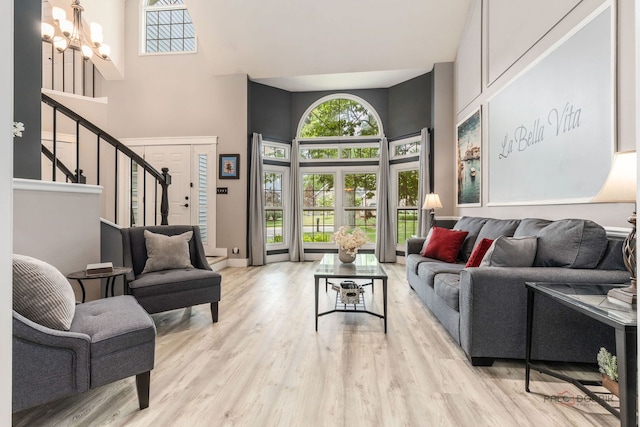 300 Knox Park Rd, Lake Zurich, IL 60047 - living room featuring a towering ceiling, a chandelier, stairs, and wood finished floors