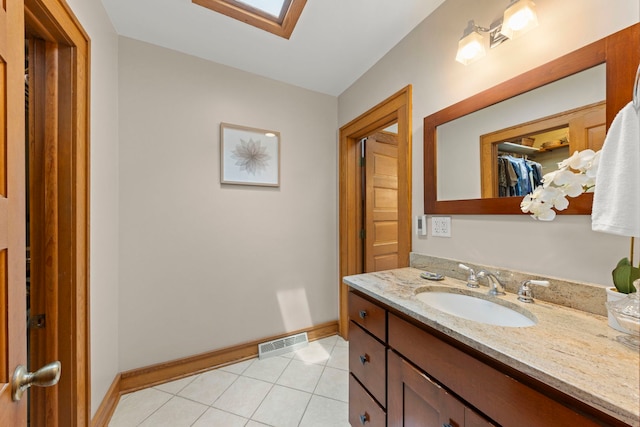 310 Forest Ave, Glen Ellyn, IL 60137 - bathroom featuring vanity, tile patterned floors, a skylight, and a spacious closet
