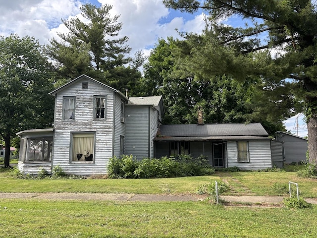 218 S Washington St, Lacon, IL 61540 - traditional-style house featuring a front lawn, a chimney, and a sunroom