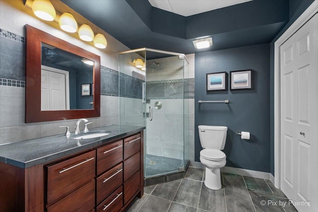 1327 Brown St Unit 206, Des Plaines, IL 60016 - bathroom featuring toilet, vanity, a stall shower, baseboards, and tile patterned flooring