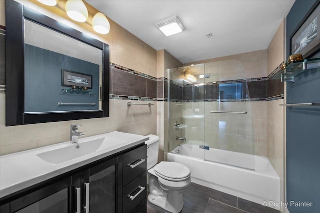 1327 Brown St Unit 206, Des Plaines, IL 60016 - full bathroom featuring toilet, vanity, tile patterned floors, shower / washtub combination, and tile walls