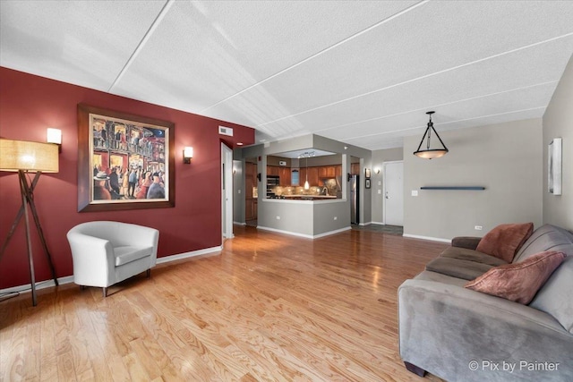 1327 Brown St Unit 206, Des Plaines, IL 60016 - living area with wood finished floors, baseboards, and a textured ceiling