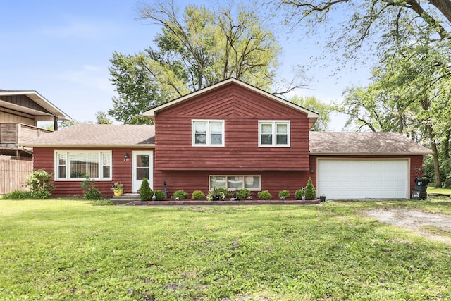 201 N First St, Wilmington, IL 60481 - tri-level home featuring driveway, an attached garage, a front lawn, and a shingled roof