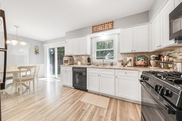 201 N First St, Wilmington, IL 60481 - kitchen featuring black appliances, a sink, plenty of natural light, and backsplash