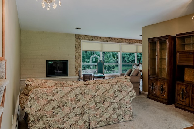 living room featuring carpet floors, a large fireplace, and a chandelier