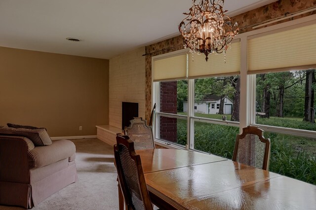 dining room with a chandelier and baseboards