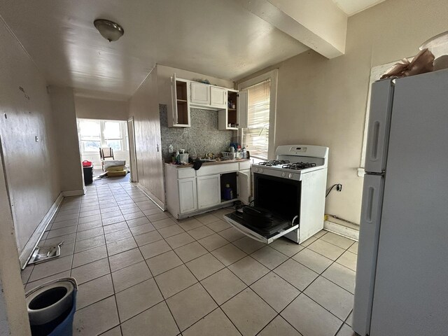 6812 S Hermitage Ave, Chicago, IL 60636 - kitchen with white appliances, light tile patterned floors, white cabinets, and open shelves