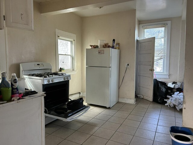 6812 S Hermitage Ave, Chicago, IL 60636 - kitchen with white appliances, light tile patterned floors, light countertops, and white cabinets
