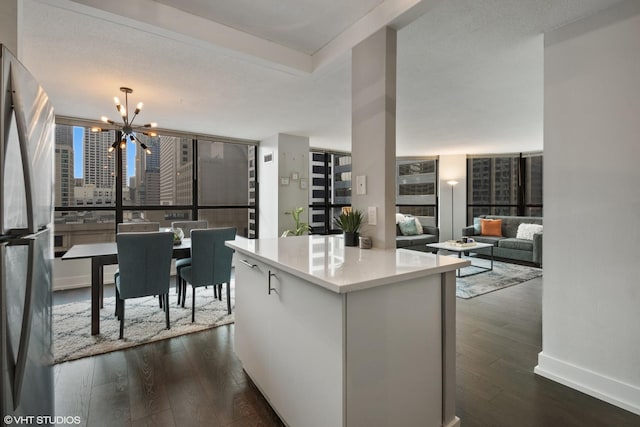 405 N Wabash Ave Unit 713, Chicago, IL 60611 - kitchen with a chandelier, freestanding refrigerator, dark wood-type flooring, and light countertops