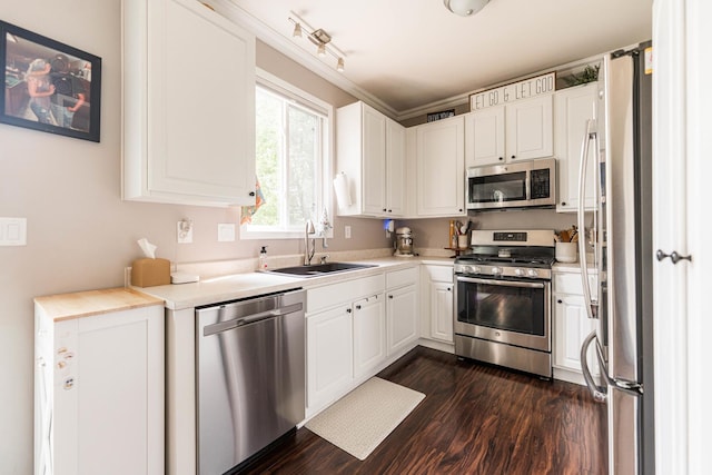 86 E Hummingbird Ave, Cortland, IL 60112 - kitchen with stainless steel appliances, a sink, dark wood-style floors, light countertops, and white cabinetry