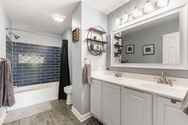 86 E Hummingbird Ave, Cortland, IL 60112 - bathroom featuring wood finished floors, toilet, shower / bath combination with curtain, double vanity, and baseboards