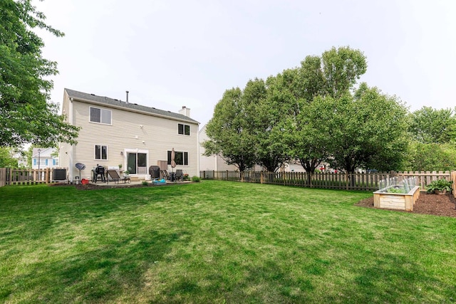 86 E Hummingbird Ave, Cortland, IL 60112 - rear view of property with a chimney, a patio area, cooling unit, and a vegetable garden