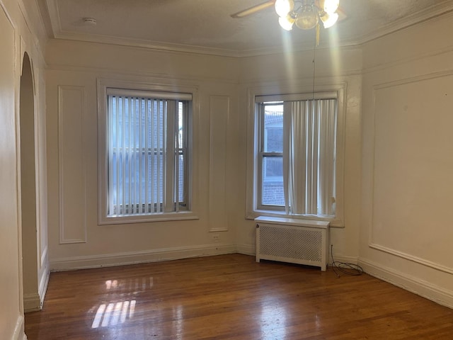 6832 S S Shore Dr Unit 1, Chicago, IL 60649 - empty room with radiator, a ceiling fan, wood finished floors, a smoke detector, and ornamental molding