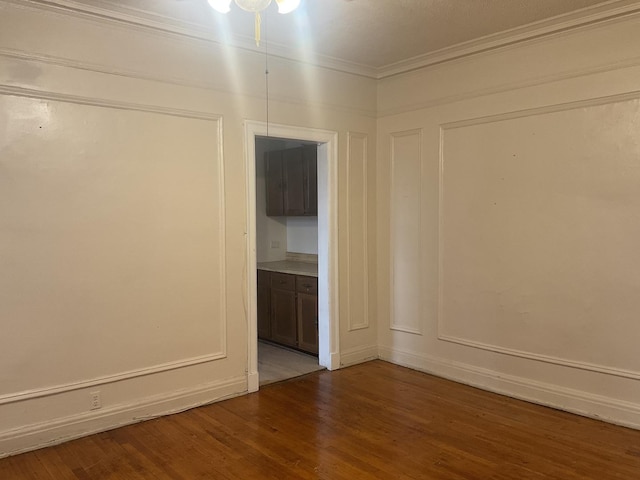 6832 S S Shore Dr Unit 1, Chicago, IL 60649 - spare room with wood finished floors, ornamental molding, and ceiling fan