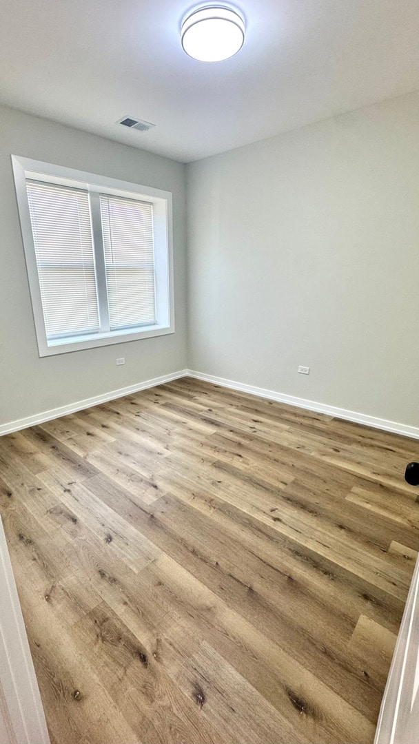 1110 W Marquette Rd, Chicago, IL 60621 - empty room with baseboards and wood finished floors
