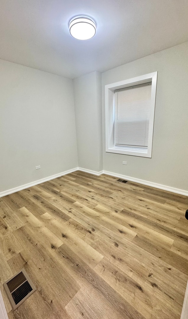 1110 W Marquette Rd, Chicago, IL 60621 - unfurnished room with wood finished floors and baseboards