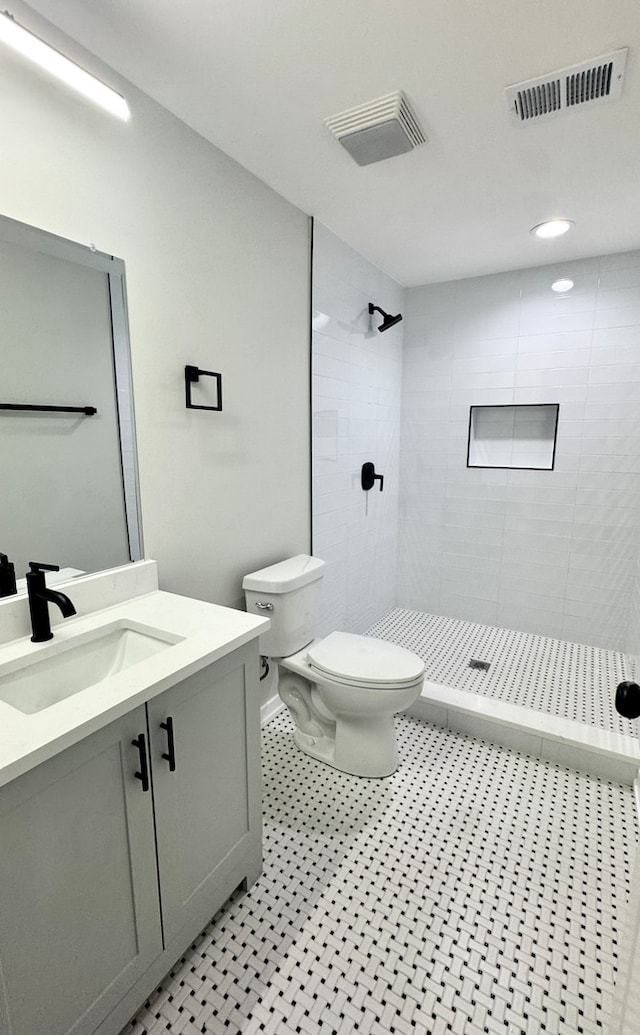 1110 W Marquette Rd, Chicago, IL 60621 - bathroom featuring toilet, vanity, tiled shower, and tile patterned floors