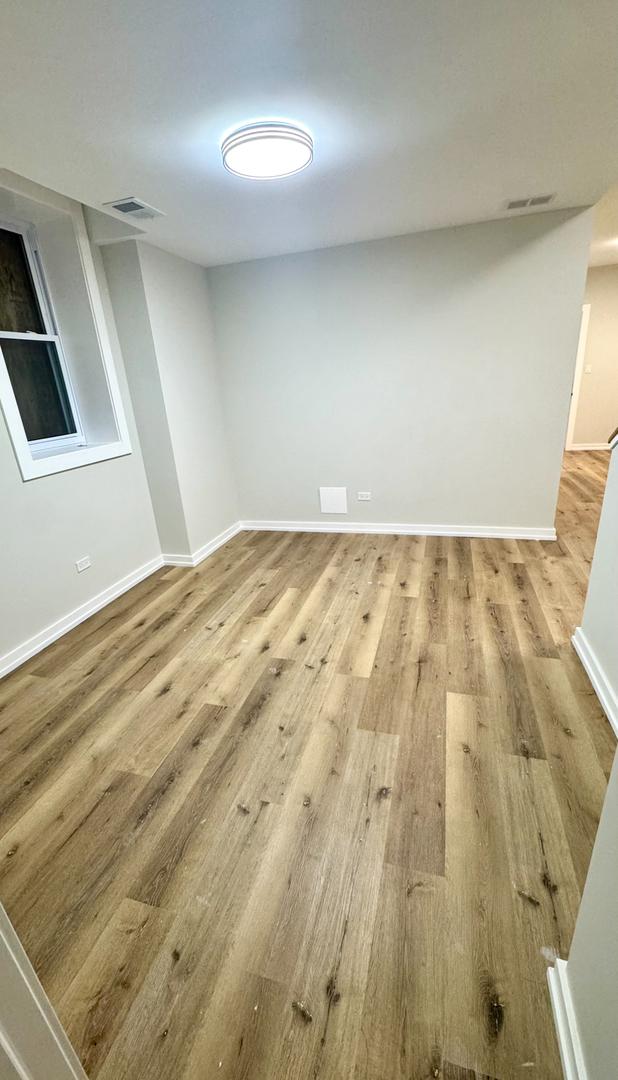 1110 W Marquette Rd, Chicago, IL 60621 - spare room with light wood-type flooring and baseboards
