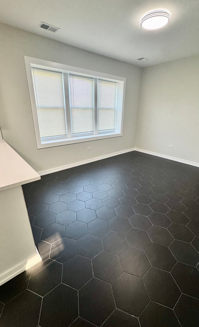 1110 W Marquette Rd, Chicago, IL 60621 - empty room featuring dark tile patterned flooring and baseboards