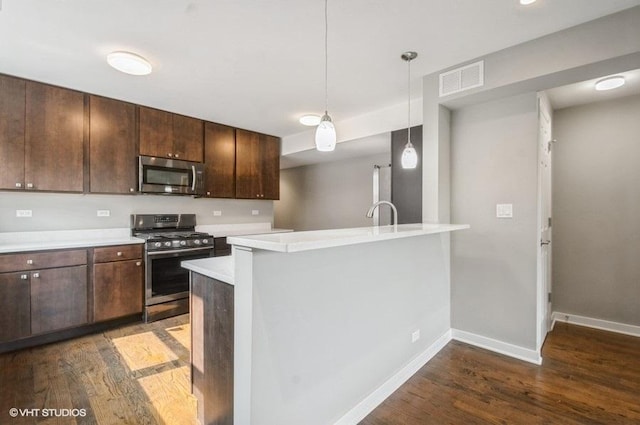 2553 W Summerdale St Unit 2E, Chicago, IL 60625 - kitchen with stainless steel appliances, dark wood-type flooring, light countertops, and dark brown cabinetry
