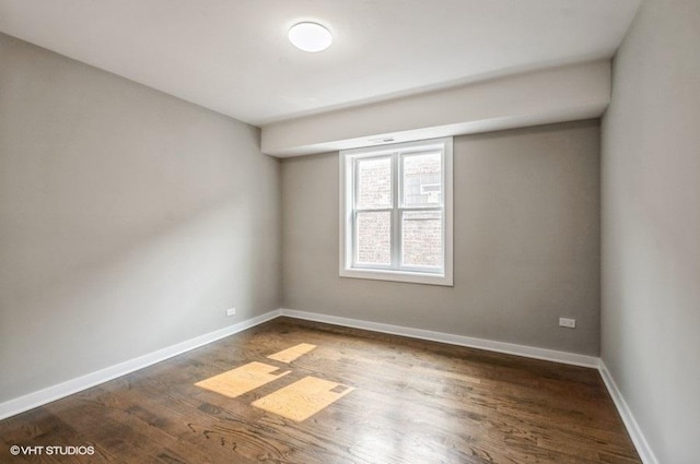 2553 W Summerdale St Unit 2E, Chicago, IL 60625 - unfurnished room with dark wood-style floors and baseboards