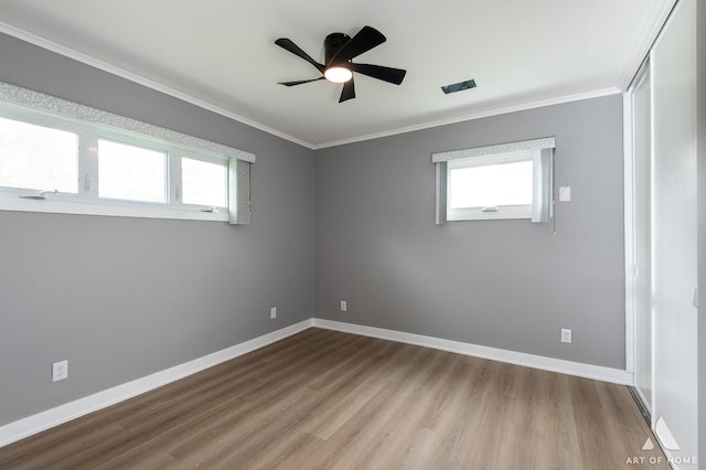 16568 Plainview Dr, Markham, IL 60428 - unfurnished room with healthy amount of natural light, wood finished floors, ornamental molding, ceiling fan, and baseboards