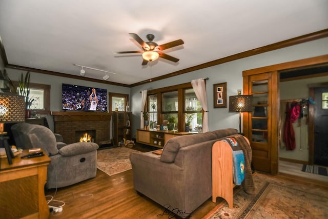905 Kelly Ave, Joliet, IL 60435 - living area featuring a ceiling fan, ornamental molding, a brick fireplace, and wood finished floors