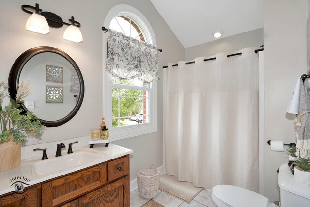 883 White Tail Bnd, Manteno, IL 60950 - full bathroom featuring toilet, vaulted ceiling, vanity, tile patterned floors, and plenty of natural light