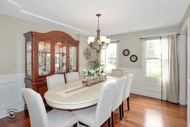 883 White Tail Bnd, Manteno, IL 60950 - dining space featuring a chandelier, wainscoting, light wood-style floors, and a decorative wall