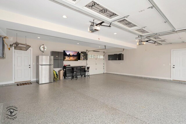 883 White Tail Bnd, Manteno, IL 60950 - garage with freestanding refrigerator, a garage door opener, baseboards, and recessed lighting