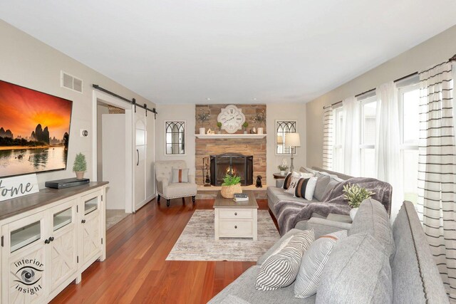 883 White Tail Bnd, Manteno, IL 60950 - living room with a barn door, wood finished floors, and a fireplace