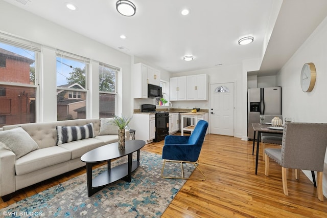 3849 W Ainslie St Unit 1, Chicago, IL 60625 - living room with light wood-style flooring and recessed lighting