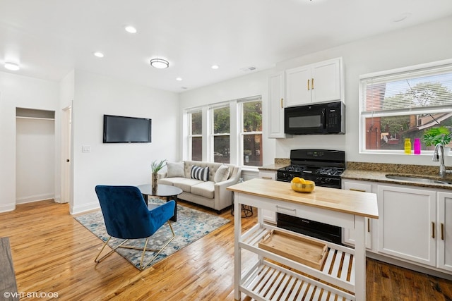 3849 W Ainslie St Unit 1, Chicago, IL 60625 - living room featuring light wood-style floors, recessed lighting, and baseboards