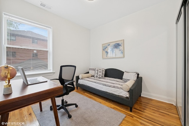 3849 W Ainslie St Unit 1, Chicago, IL 60625 - bedroom with light wood-type flooring, a desk, and baseboards