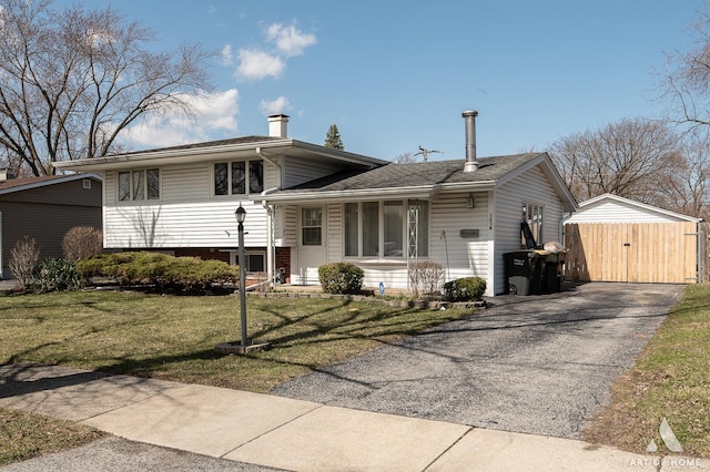 3034 190th St, Lansing, IL 60438 - view of front of house with a front yard, asphalt driveway, a chimney, and a gate