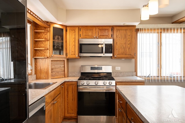 3034 190th St, Lansing, IL 60438 - kitchen with appliances with stainless steel finishes, brown cabinetry, a sink, and light countertops