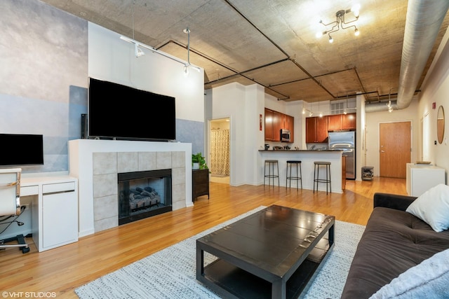 520 S State St Unit 614, Chicago, IL 60605 - living room with light wood-style flooring, rail lighting, a fireplace, and a desk